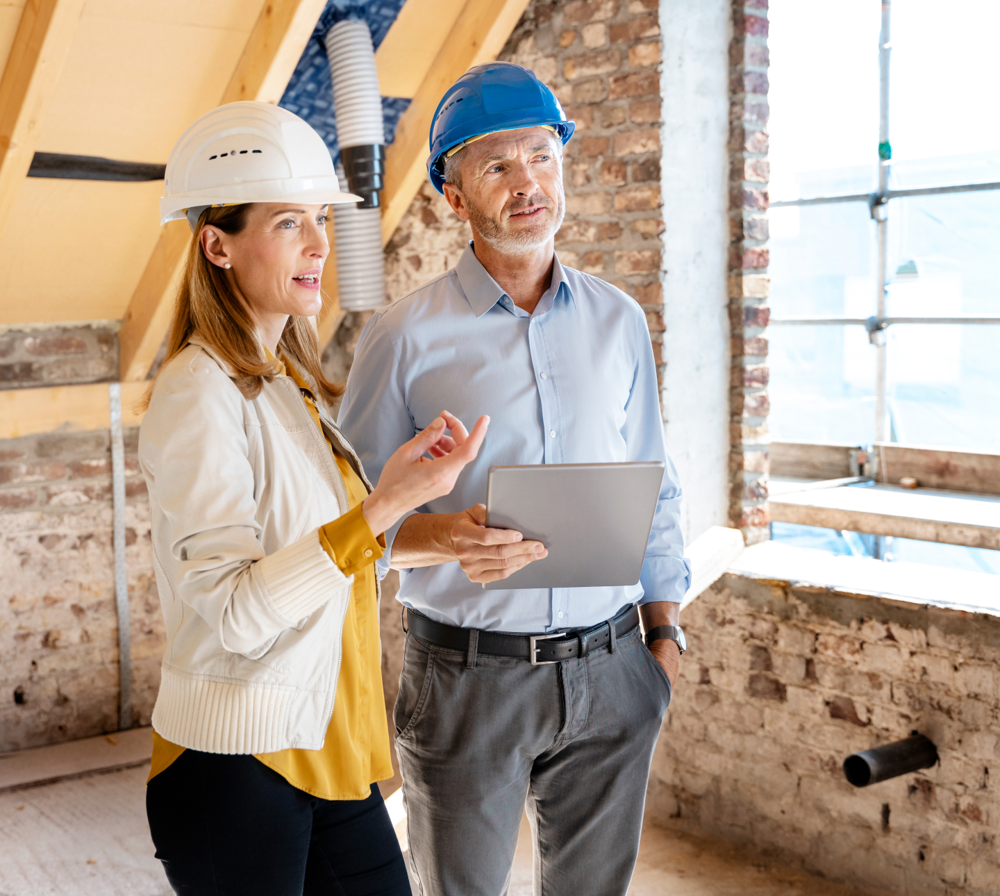 Man and woman at construction site conversing