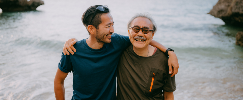 Dad and son laughing at the beach