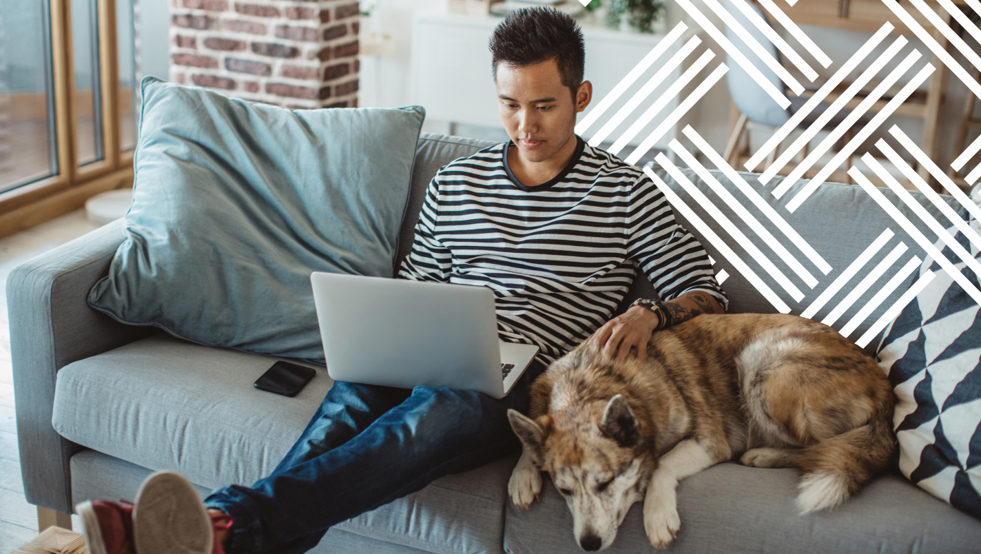 Man on couch with dog browsing
