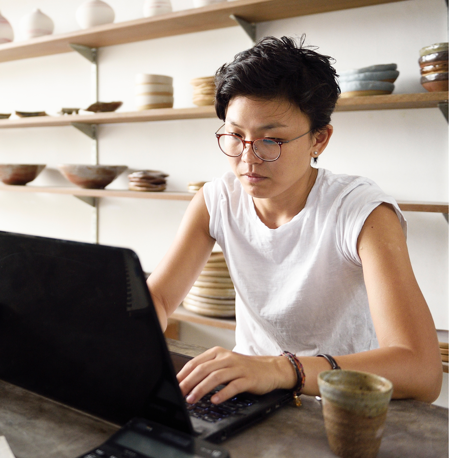 Woman organizing finances at the table on the phone