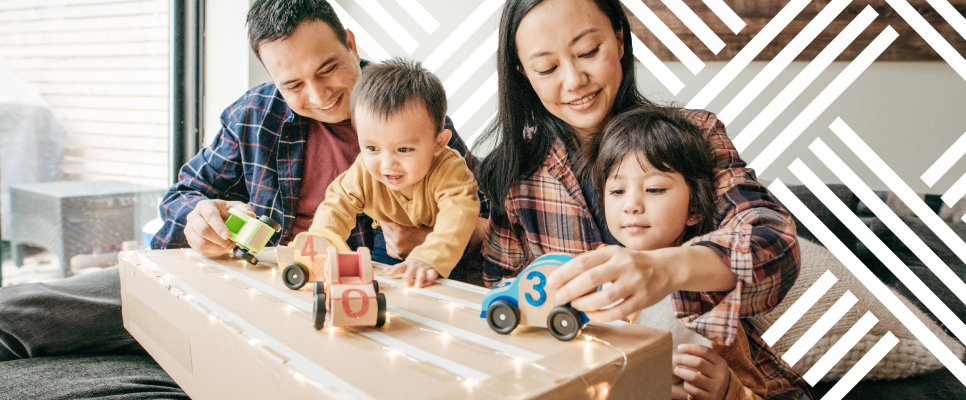 Young family playing on moving box