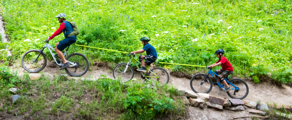 Family biking up a hill