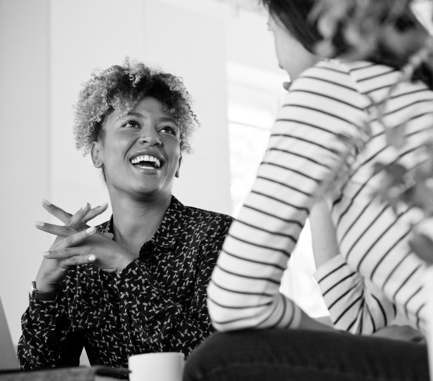 Woman laughing with advisor or friend